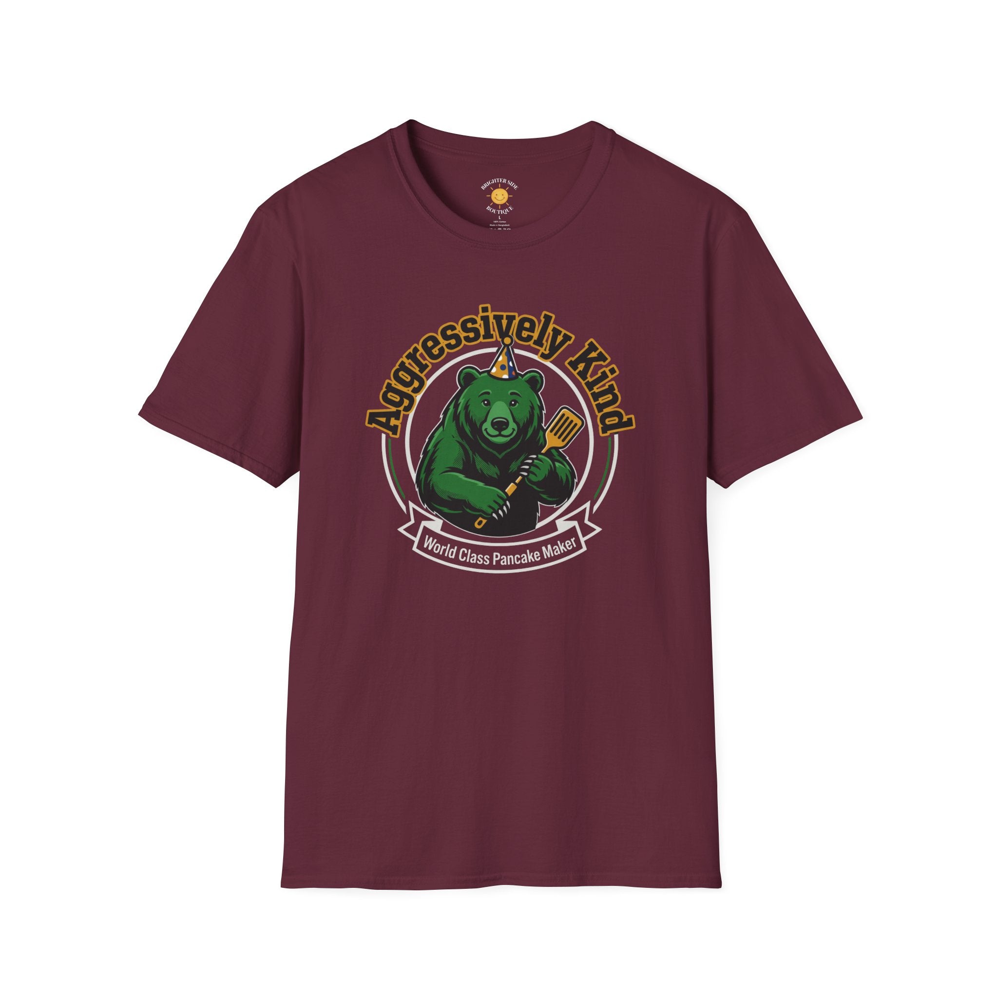 Vintage-style graphic featuring a happy green bear wearing a party hat and holding a spatula with the phrases "Aggressively Kind" and "World Class Pancake Maker."